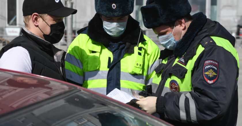 Сотрудники ГИБДД проверяют документы у водителя в рамках профилактических работ по защите населения от распространения коронавирусной инфекции. Александр Кряжев / РИА Новости