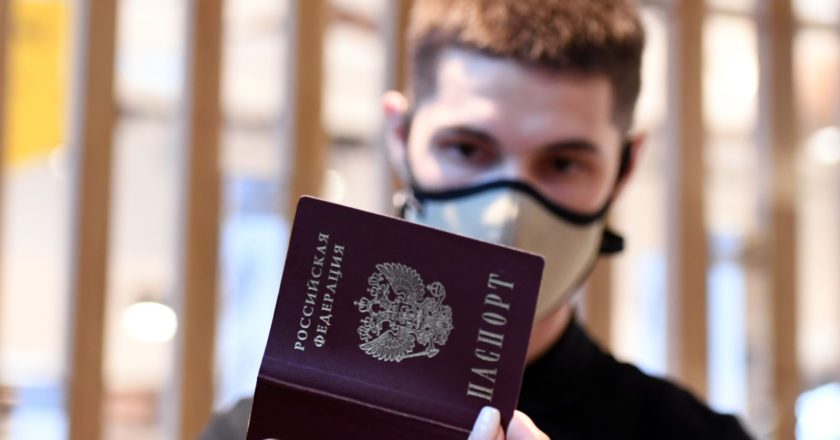 Сотрудник безопасности сверяет данные документа удостоверяющего личность с данными в QR-коде у посетителей на входе в парфюмерный супермаркет "Золотое яблоко" в Казани. Максим Богодвид / РИА Новости