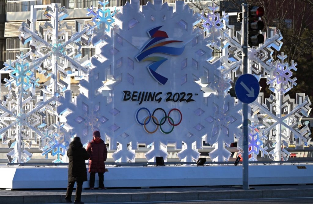 Прохожие фотографируются у стелы с символикой зимних Олимпийских игр 2022 в Пекине. Григорий Сысоев / РИА Новости